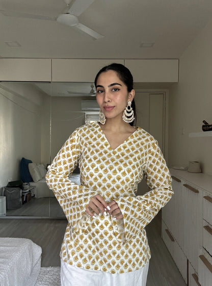 “Woman wearing off‑white yellow printed bell sleeves kurti – Gunjan front view”

