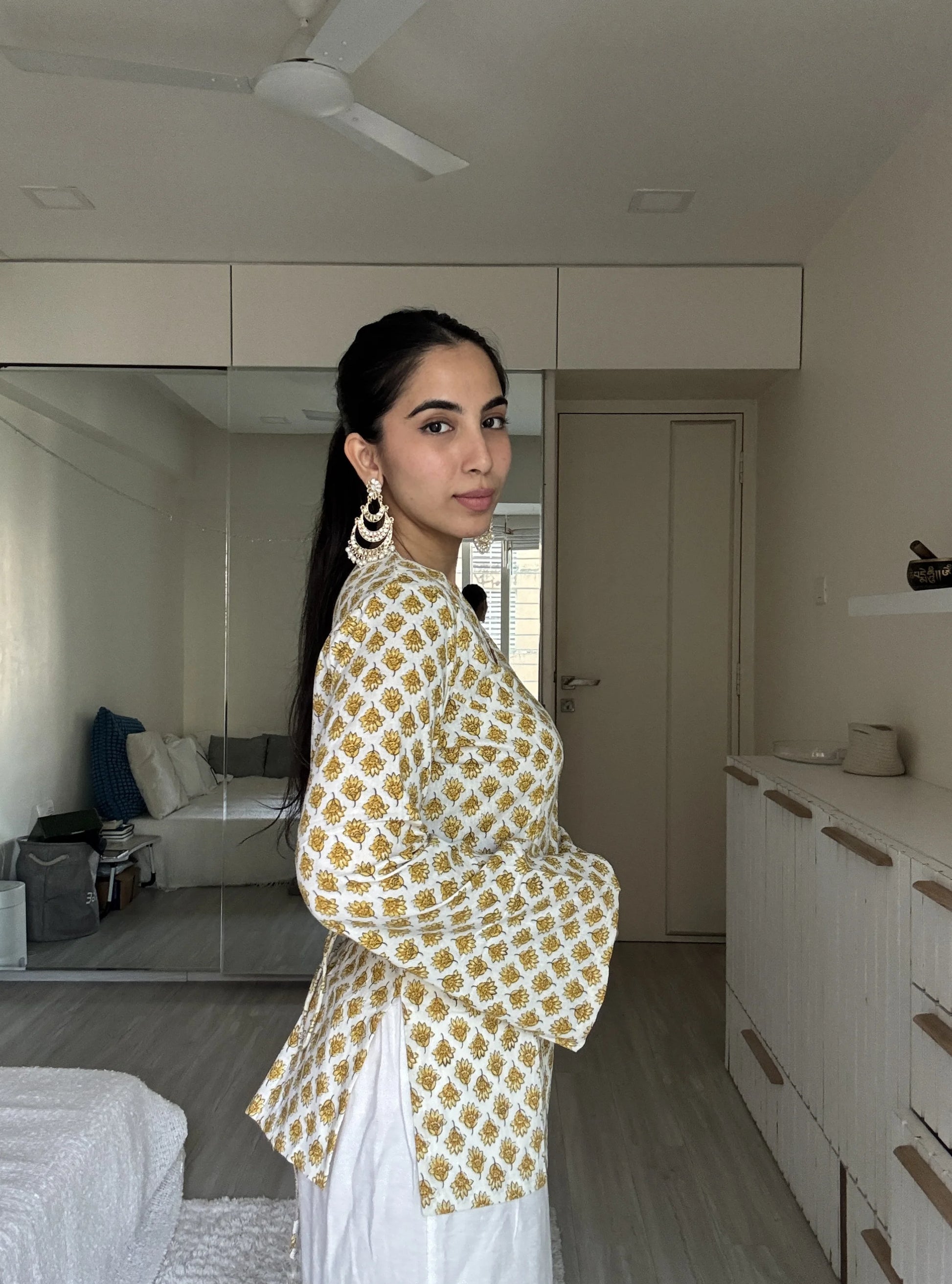 “Woman wearing off‑white yellow printed bell sleeves kurti – Gunjan front view”