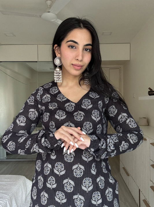 “Woman wearing black floral long sleeved kurti – Maya front view”
