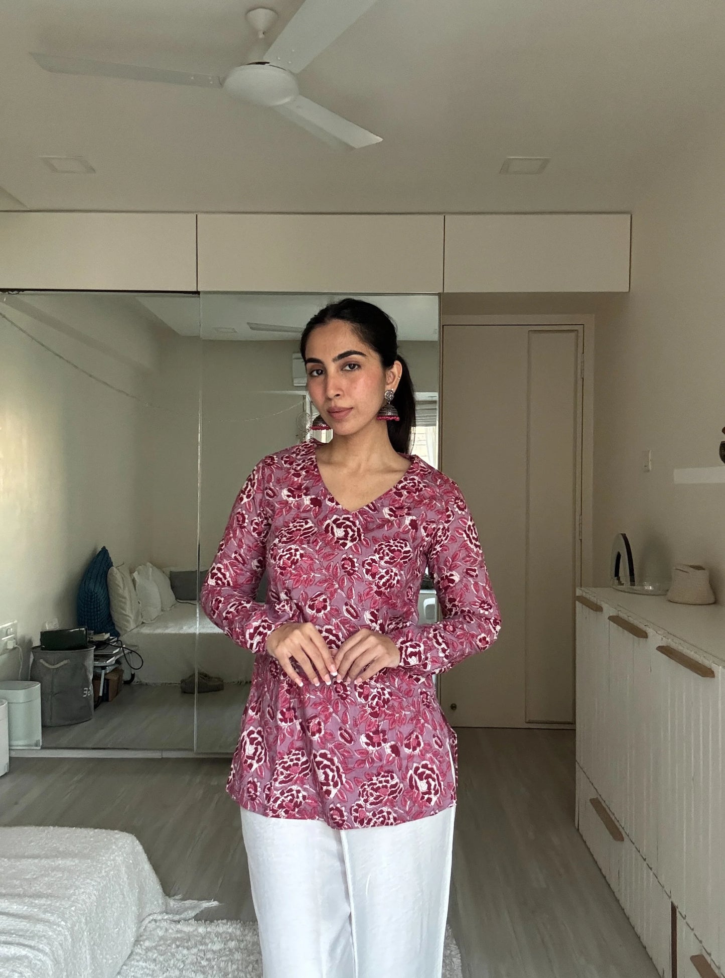 “Woman wearing pink floral long sleeved kurti – Tanisha front view”