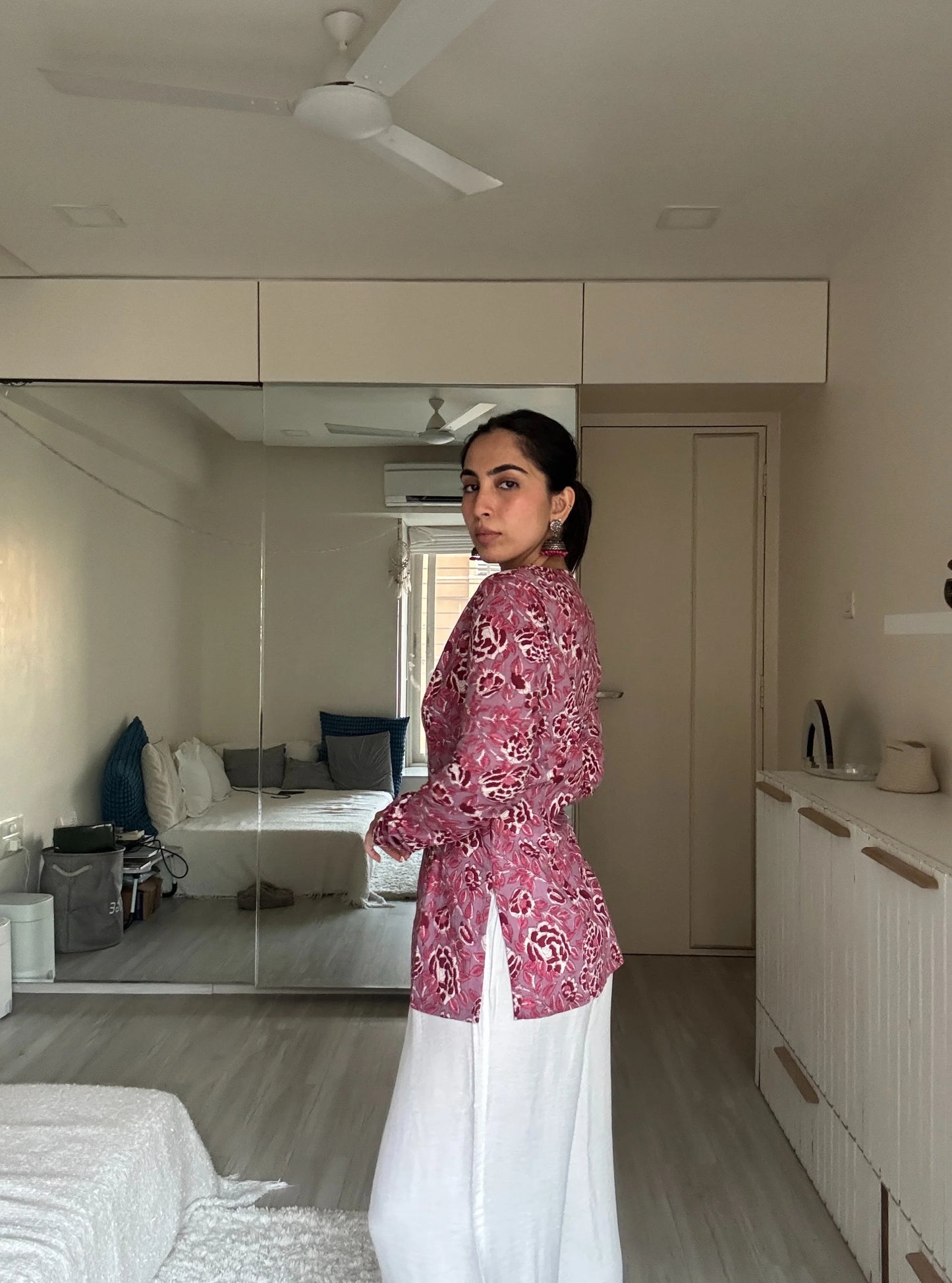 “Close‑up of pink floral print and V‑neckline on Tanisha kurti”