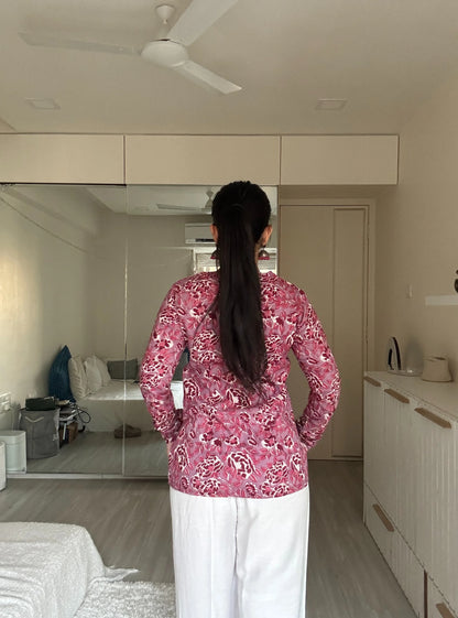 “Side view of Tanisha pink floral long sleeved kurti styled with white pants”