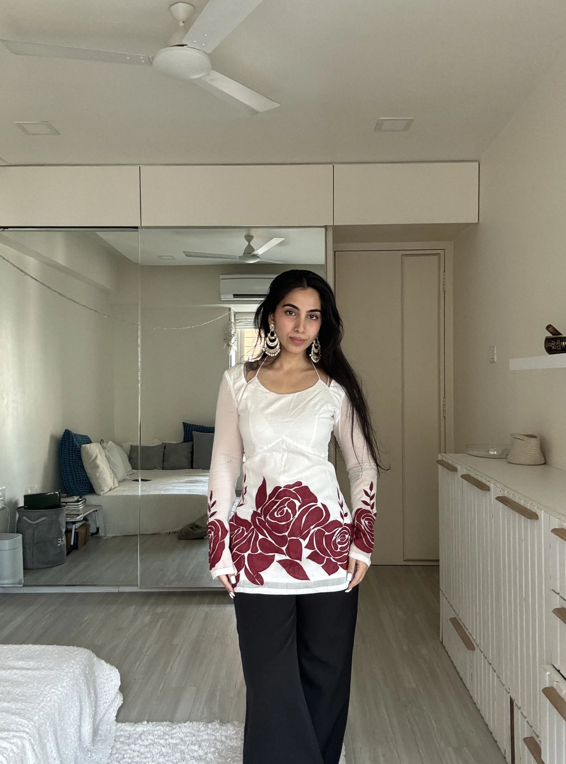 “Red rose motif along hemline of Surbhi off‑white long sleeved kurti”
