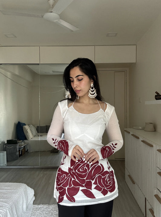 “Woman wearing off‑white kurti with red rose print sleeves and hem – Surbhi front view”