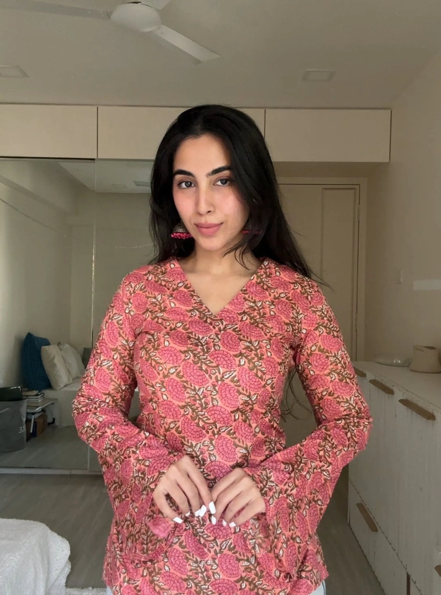 “Woman wearing pink floral bell sleeves kurti – Urvi front view”