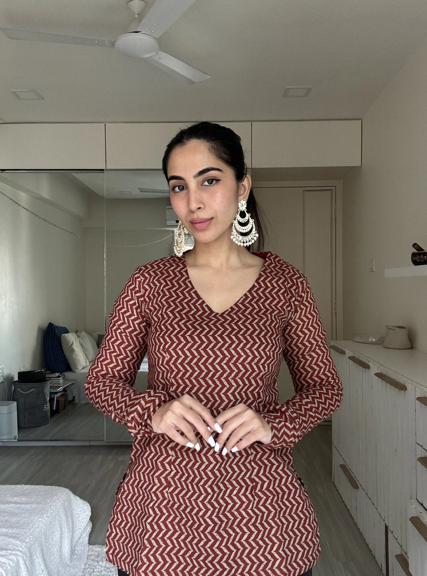 “Woman wearing maroon beige zigzag print long sleeved kurti – Vaani front view”