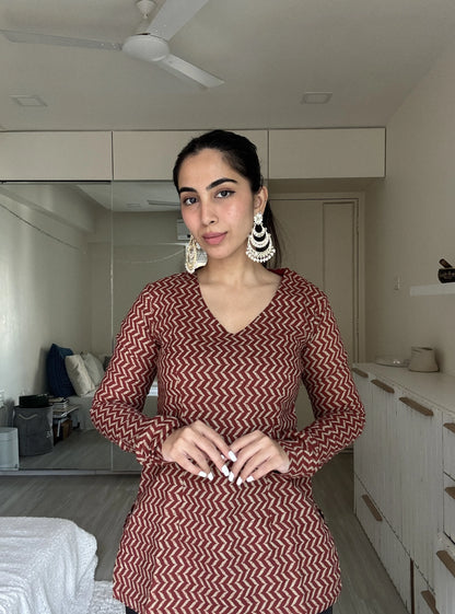 “Woman wearing maroon beige zigzag print long sleeved kurti – Vaani front view”